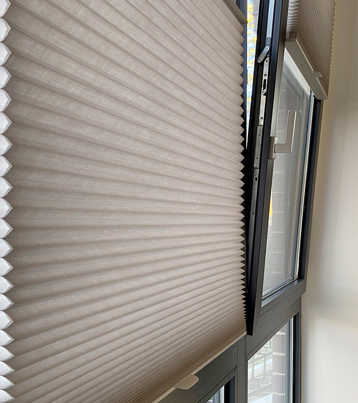 Cellular shades on a window in a room.