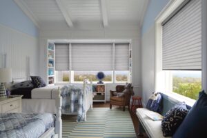 Childs bedroom with windows that has Sonnette Cellular Roller Shades installed