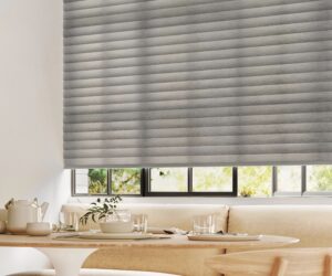 Dining room table near a window with Sonnette Cellular Roller Shades installed