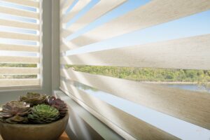 Close up of a window above a vase with Designer Banded Shades installed
