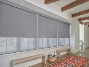 3 windows in a hallway with benches that have Designer Roller Shades installed
