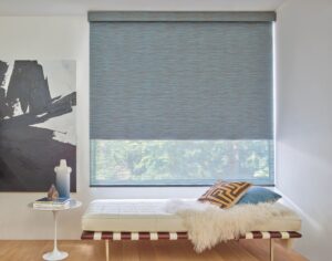 Widnow above a single bed in a bedroom with Designer Roller Shades installed