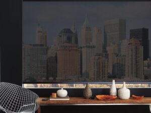 Desk with vases on it below a window with Red chair in the corner of an office with a big window with Designer Screen Shades installed