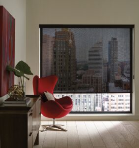 Red chair in the corner of an office with a big window with Designer Screen Shades
