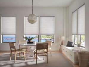 Modern dining area with Hunter Douglas Applause honeycomb shades in the background