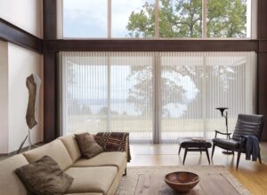 Living room with couch in front of window covered with Luminette Privacy Sheers