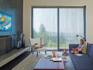 Large media room with sliding doors covered in Luminette Privacy Sheers
