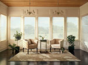Two white chairs in a sun room with Nantucket Window Shadings