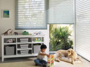 Boy playing in a playroom with Nantucket Window Shadings