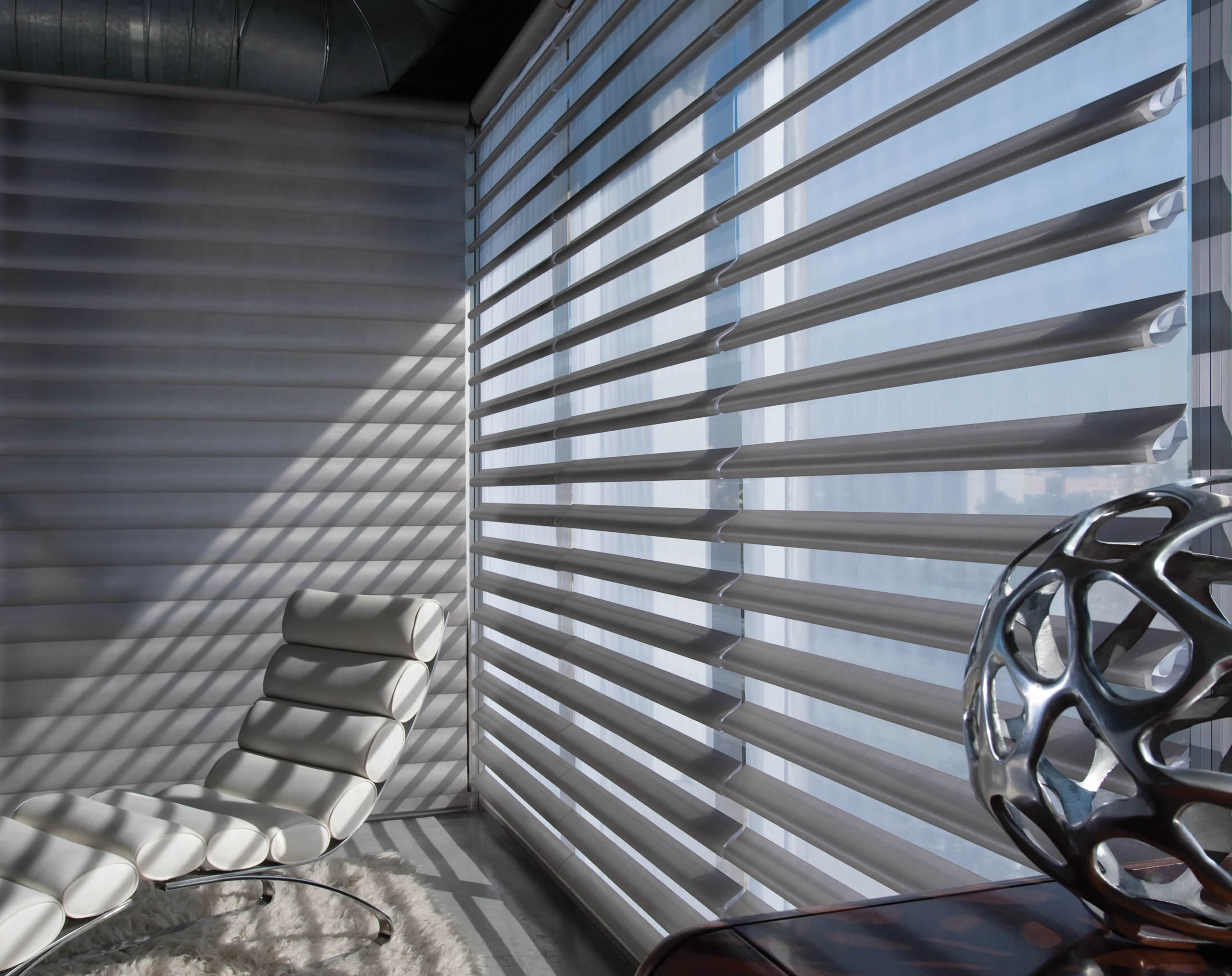 Pirouette® Sheer Shades letting sunlight through a big window