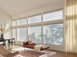 Custom designed couch in living room with windows covered in Pirouette® Sheer Shades