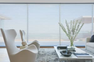 White furntiure in living room with bay window covered with Silhouette® Window Shadings