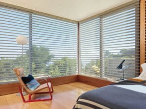 Chair in a bedroom looking out a window with Silhouette® Window Shadings