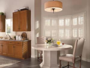 Dining room with small nook in front of windows covered in NewStyle Hybrid Shutters
