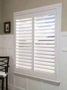 Dining room with a small window with Palm Beach Polysatin Shutters installed