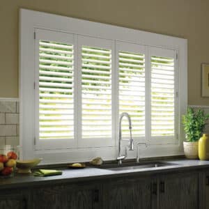 Kitchen with bi-fold hinged Palm Beach Polysatin Shutters installed