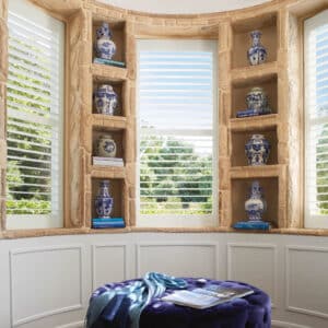 Study with bookshelves between windows with Palm Beach Polysatin Shutters