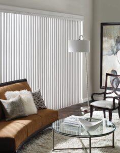Bright living room with Cadence Soft Vertical Blinds installed on the big bay window