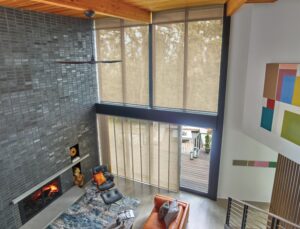 Overhead view of living room with floor to ceiling windows covered in Skyline Gliding Window Panels