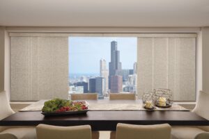 Conference room with a city view through windows that are covered with Skyline Gliding Window Panels