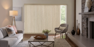 Living room with a couch and chair near window with Cadence Soft Vertical Blinds installed
