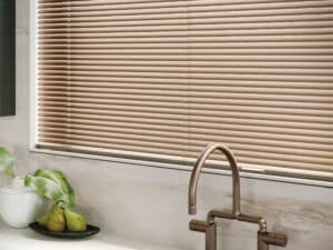 Window above a kitchen sink that has Modern Precious Metals Venitian Blinds installed
