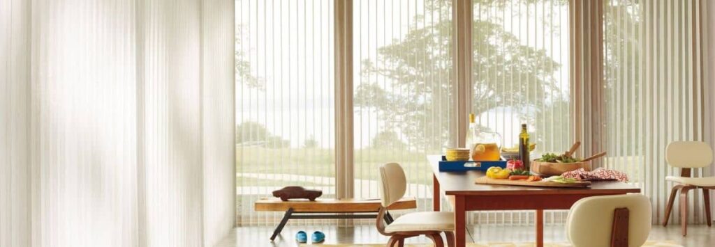 A dining room with white blinds and a table adorned in the best window coverings.